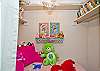 Reading nook in master bedroom; fun pink patchwork decor with shelving for books and cute chandelier!