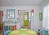 Views of the spacious, open living and dining area. Bright, colorful and fun! This area includes a bar with extra seating; fun place to sit and have a snack!