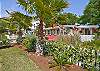 The front of the cottage is full of a beautiful garden area and seating.