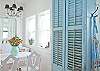 Our full equipped and stocked kitchen has everything you need to be creative with our coastal food treasures.  The seating area is part of the kitchen.  The blue shutters are from a local antique store repurposed as doors.