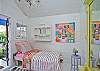 The back cottage is a little haven. Great for lounging or kids that want to "glamp" (glamour camp!) Two twin beds, AC, bright and cheerful local art and unique cottage decor.