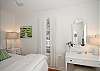 King bedroom; crisp cottage white featuring local art and lots of cottage charm! Flatscreen TV!