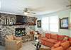 This area is a combination living space- family room with large flat screen TV, lots of seating, small step up to dining room area and leads to the kitchen as well.