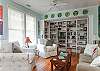 The cottage has a very open layout. This is the large family room with cable TV and library, dining room and even the kitchen. There is also a wood burning fireplace. Tall ceilings and lots of natural lighting.