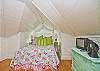 The bed is covered with Pinecone hill bedding and pillows.  Bright and so cheerful.  There is also a cable tv with this bedroom area.