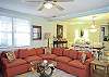 This area is a combination living space- family room with large flat screen TV, lots of seating, small step up to dining room area and leads to the kitchen as well.