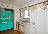 Another view of kitchen. Great aqua china cabinet; this cottage is full of fun color!