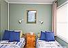 This bedroom has two twin beds as well as cable TV.