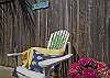 The fully enclosed back yard has a table and chairs ( with umbrella), seating and outdoor art. The outer building in the enclosed backyard/ courtyard also includes the laundry room.