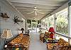 The screened porch has lots of outdoor seating including a table for 4-6.