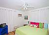 King bedroom. Splashes of color and fun wall hangings make this room a favorite!