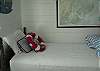 This bright and cheerful bedroom features 3 twin beds. The decor is vintage nautical with red, white and blue bedding, vintage treasures and lots of natural light.  Great bedroom!