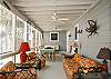 The screened porch has lots of outdoor seating including a table for 4-6.