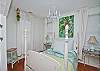 The bedroom features orignal art from local artist Bellamy Murphy. The bedding is Pinecone Hill and beautiful shades of blue and green.
