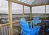 Third floor screened porch seating.