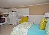This photo shows the bed area as well as the kitchen area in the back studio apartment.