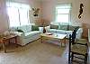 Our living room has a sofa, love seat, Cable TV, and wonderful photography from the owners! Great space!