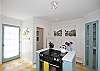 Overview of large, spacious kitchen; very bright and cheerful with yellow/white tile floor and quaint corner panty.