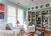 The cottage has a very open layout. This is the large family room with cable TV and library, dining room and even the kitchen. There is also a wood burning fireplace. Tall ceilings and lots of natural lighting.