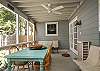 The screened porch has lots of seating as well as a large farm style table and chairs to enjoy meals or playing games.
