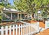 Front exterior view of Nora's Cottage! Picture perfect beach cottage complete with white picket fence! Adorable!