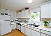 Kitchen area. The main room of the cottage is one big family room. Big open kitchen, dining room tables and family area. Bright and cheerful, freshly renovated.