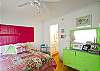 Downstairs bedroom #1. Queen bed and lots of fun pink and lime green!