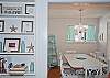 View of dining area and adorable built-in wall shelf with lots of fun beach accents!