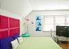 Bedroom #2 upstairs; features a king bed and TV.  Lots of bright, fun color and great natural light!