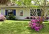 Barefoot Bliss is surrounded by palm trees, crepe myrtles and azaleas in the front. The spring time is a picture of color!