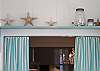 Shelf above kitchen sink; seashells galore!