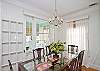 The dining room table seats 8 people and has a classic crystal chandelier hanging above the table.  The Chandelier came from an old historic house in downtown Savannah