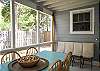 The screened porch has lots of seating as well as a large farm style table and chairs to enjoy meals or playing games.