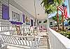 Front exterior of Inlet Breeze cottage. Notice the fantastic white picket fence and all of the wonderful details and colorful shutters and door!