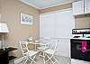 The studio apartment kitchen area. A full size stove/oven and refrigerator. Basic kitchen equipment including coffee maker. Dining seating for 3.