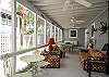 The screened porch has lots of outdoor seating including a table for 4-6.
