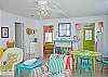 Views of the spacious, open living and dining area. Bright, colorful and fun! This area includes a bar with extra seating; fun place to sit and have a snack!