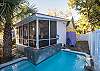 Back screened porch overlooking pool.
This wonderful pool features a crab fountain constantly blowing water into the pool! What a fun addition to the cottage!
