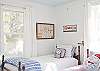 This nautical themed bedroom has three full size twin beds. Ideal for a family or for a girls' weekend. (Book club anyone?)