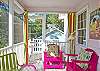 Bright, colorful screened porch awaits you at Barefoot Children!