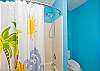 Upstairs master bathroom; double sinks, fun blue beachy color and lots of natural light!
