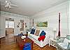 This large light filled room includes a sofa, chairs, dining room table and Cable tv.  Full of wonderful nautical details