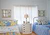 Second bedroom. This bedroom is bright and beachy and offers 2 full size beds.