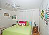 King bedroom. Splashes of color and fun wall hangings make this room a favorite!