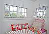 The back cottage is a little haven. Great for lounging or kids that want to "glamp" (glamour camp!) Two twin beds, AC, bright and cheerful local art and unique cottage decor.