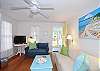 Spacious living room with 2 sofas, flatscreen TV and art from local artists! Loads of fun beach decor!