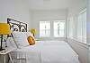The queen bed headboard is a piece of vintage iron fencing.