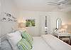 King bedroom; crisp cottage white featuring local art and lots of cottage charm! Flatscreen TV!