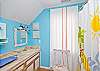 Upstairs master bathroom; double sinks, fun blue beachy color and lots of natural light!