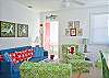 Living room area. Lots of comfy seating and bold, bright, beachy decor!